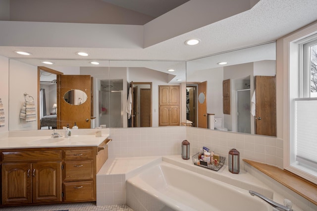 full bathroom featuring vanity, lofted ceiling, recessed lighting, a shower stall, and backsplash