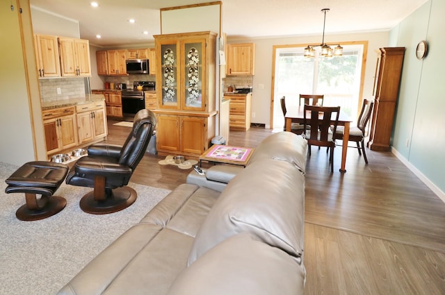 6304 Chickadee Ln SW, Alexandria, MN 56308 - living area featuring wood finished floors, baseboards, recessed lighting, a chandelier, and crown molding