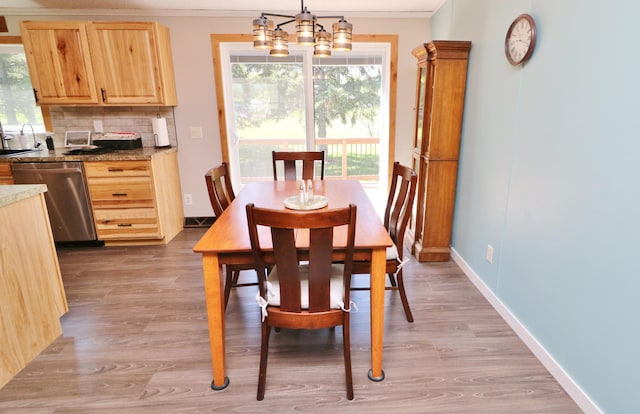 6304 Chickadee Ln SW, Alexandria, MN 56308 - dining room with crown molding, a chandelier, light wood-style floors, and baseboards