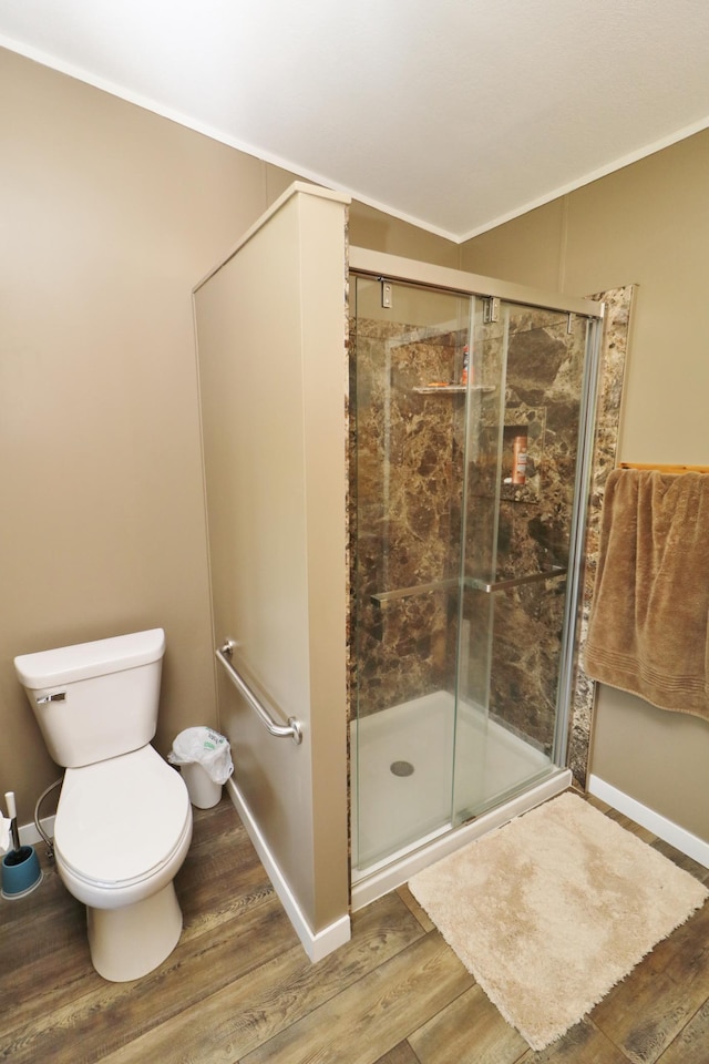 6304 Chickadee Ln SW, Alexandria, MN 56308 - full bathroom with wood finished floors, toilet, a stall shower, crown molding, and baseboards