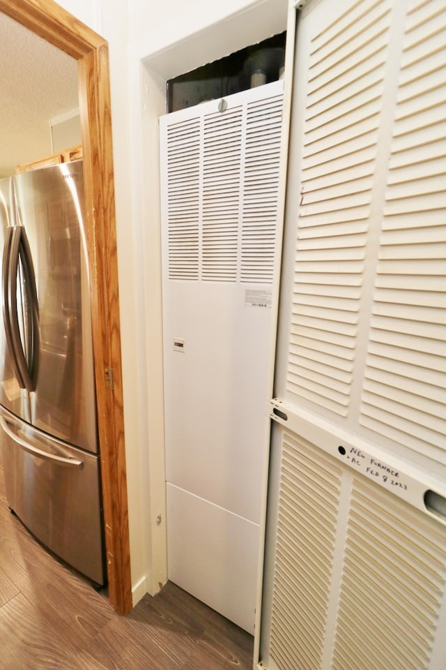 6304 Chickadee Ln SW, Alexandria, MN 56308 - laundry area with wood finished floors and a heating unit