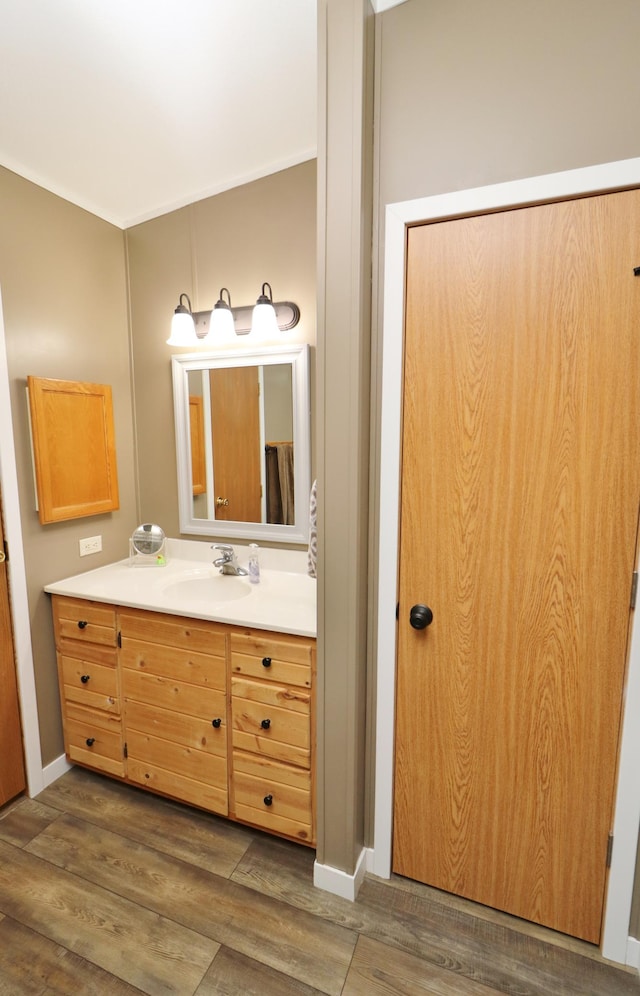 6304 Chickadee Ln SW, Alexandria, MN 56308 - bathroom with vanity, wood finished floors, and baseboards