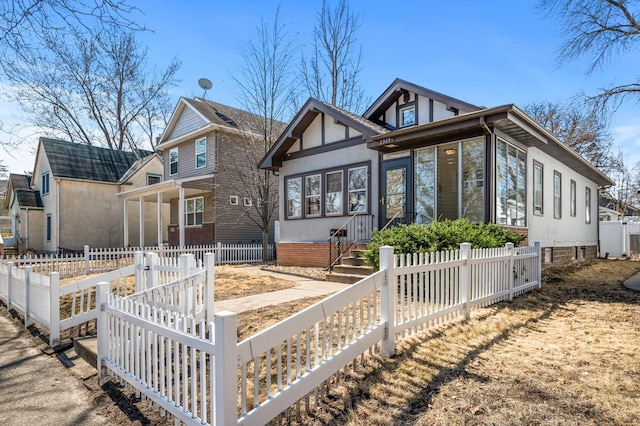 view of front of house featuring a fenced front yard and stucco siding
