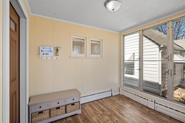 interior space featuring crown molding, a baseboard radiator, a textured ceiling, and wood finished floors