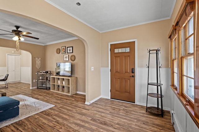 entrance foyer featuring a healthy amount of sunlight, arched walkways, and wood finished floors