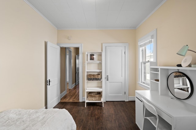 bedroom with crown molding and dark wood finished floors