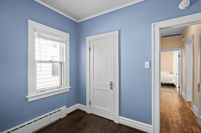 unfurnished bedroom featuring baseboards, a baseboard radiator, ornamental molding, and dark wood finished floors