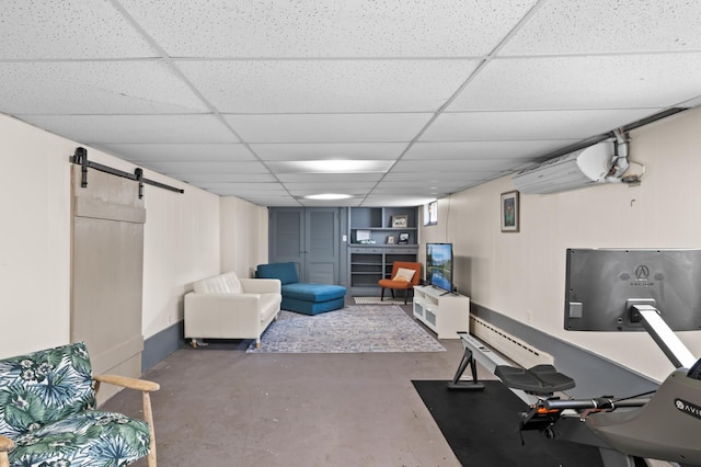 exercise area with an AC wall unit, a barn door, and a paneled ceiling