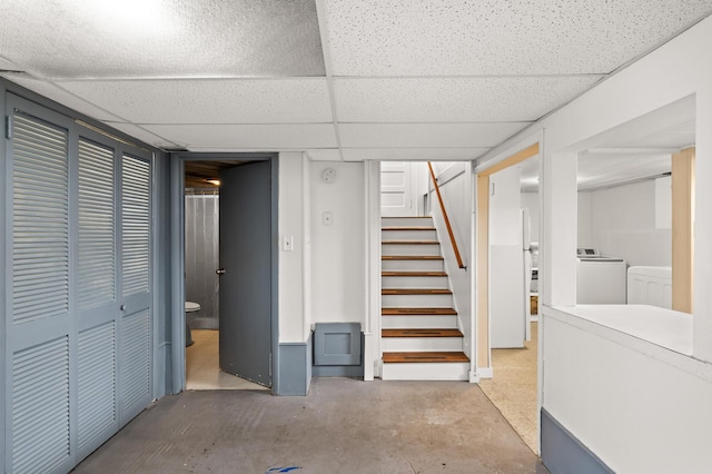 finished below grade area with stairway, washer and dryer, and a paneled ceiling