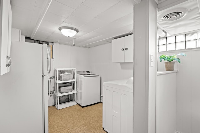 laundry room with visible vents, laundry area, light floors, and washer and dryer