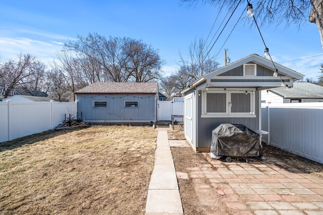 exterior space with an outdoor structure and a fenced backyard