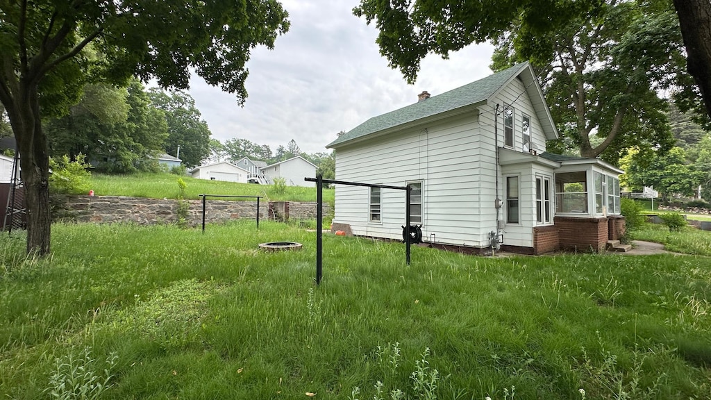 32 3rd Ave S, Sauk Rapids, MN 56379 - view of side of property with a shingled roof and a chimney