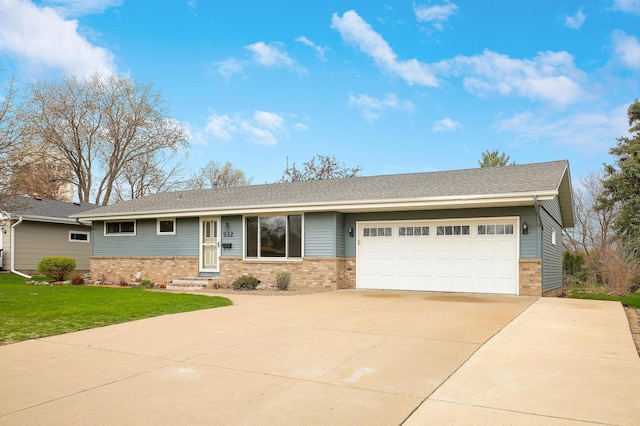 ranch-style house featuring a garage, concrete driveway, a front yard, brick siding, and entry steps