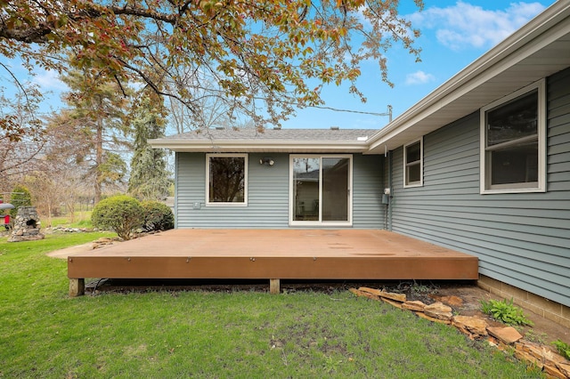 rear view of property with a lawn and a wooden deck