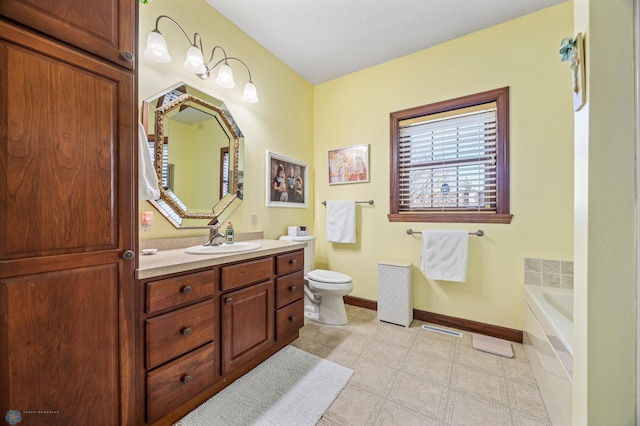 bathroom with baseboards, toilet, vanity, and a garden tub