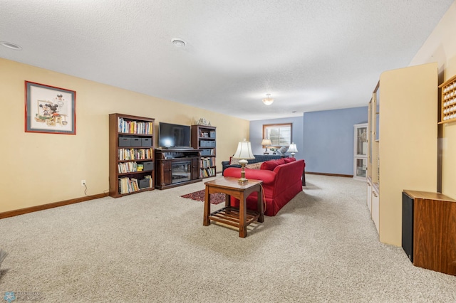 carpeted living room with baseboards and a textured ceiling