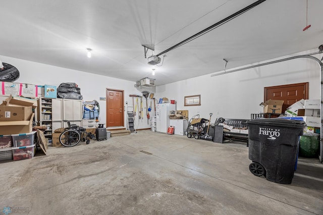 garage featuring white fridge with ice dispenser and a garage door opener