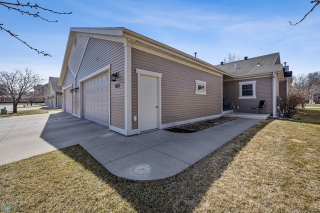 view of side of property with an attached garage and driveway