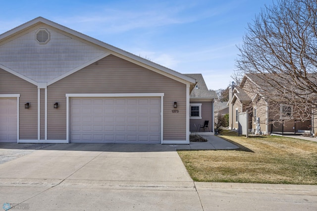 ranch-style house with concrete driveway and a front yard