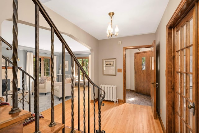 5352 15th Ave S, Minneapolis, MN 55417 - entryway featuring radiator, stairway, a chandelier, and light wood-type flooring