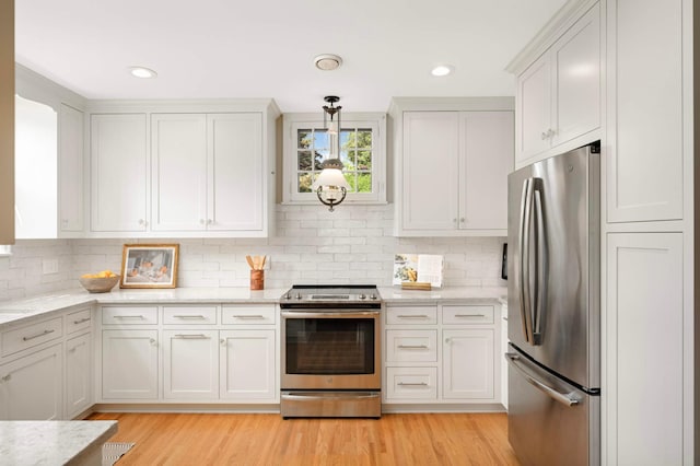 5352 15th Ave S, Minneapolis, MN 55417 - kitchen with appliances with stainless steel finishes, light wood-style flooring, tasteful backsplash, and recessed lighting