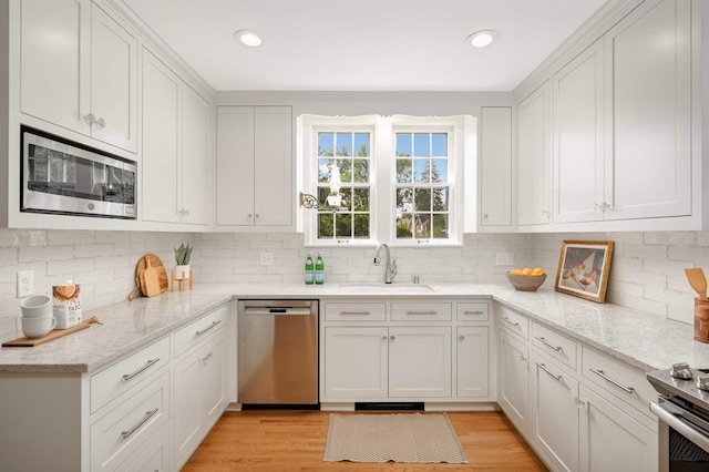 5352 15th Ave S, Minneapolis, MN 55417 - kitchen featuring stainless steel appliances, white cabinetry, backsplash, and recessed lighting