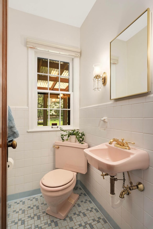 5352 15th Ave S, Minneapolis, MN 55417 - half bathroom featuring tile walls and wainscoting