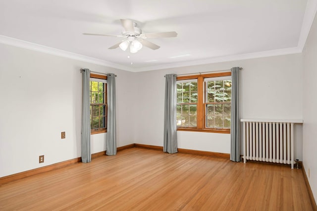 5352 15th Ave S, Minneapolis, MN 55417 - empty room featuring radiator heating unit, wood finished floors, a ceiling fan, and crown molding