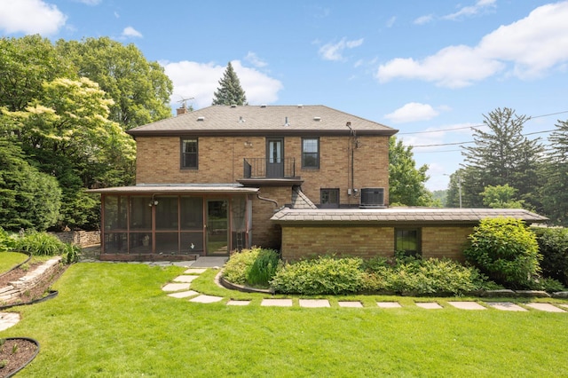 5352 15th Ave S, Minneapolis, MN 55417 - rear view of house with a balcony, a sunroom, a lawn, brick siding, and a chimney