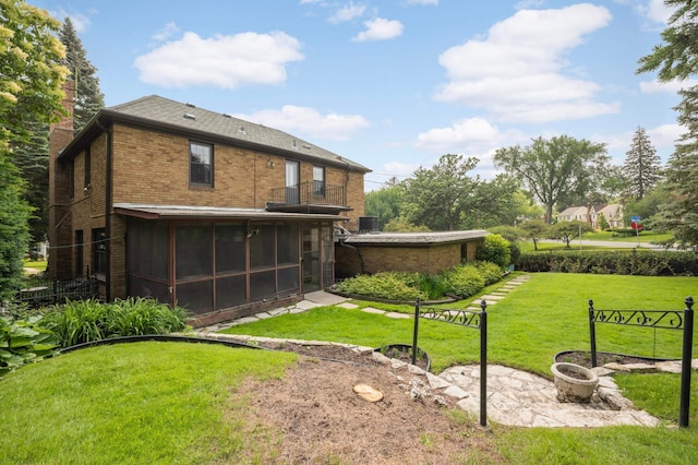 5352 15th Ave S, Minneapolis, MN 55417 - back of house featuring a balcony, a sunroom, a chimney, brick siding, and a yard