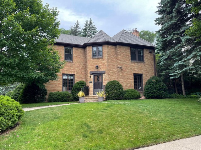 5352 15th Ave S, Minneapolis, MN 55417 - traditional-style home with a chimney, a front lawn, and brick siding