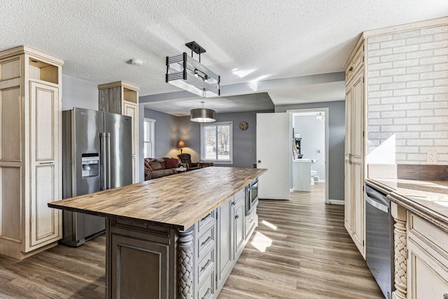 kitchen featuring dark wood finished floors, stainless steel appliances, open shelves, and butcher block counters