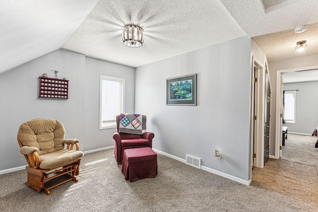 sitting room featuring baseboards, carpet flooring, a textured ceiling, and visible vents