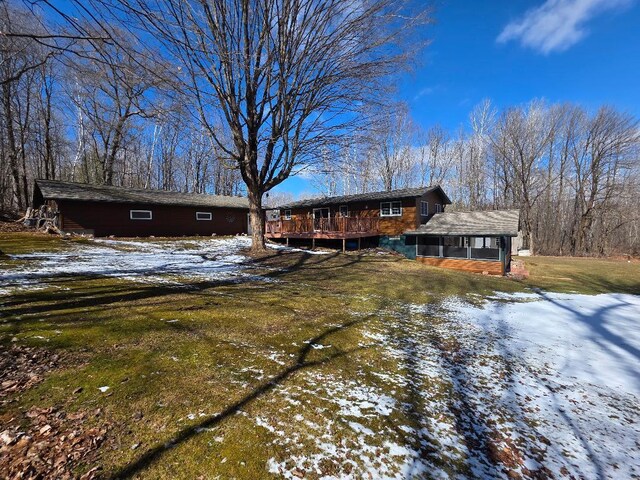 view of front of home with a yard and a deck