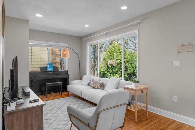 1332 Jersey Ave S, Saint Louis Park, MN 55426 - living area featuring light wood-type flooring, baseboards, recessed lighting, and a textured ceiling