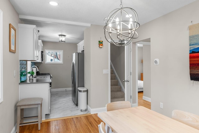 1332 Jersey Ave S, Saint Louis Park, MN 55426 - dining room with light wood-type flooring, baseboards, an inviting chandelier, recessed lighting, and stairway