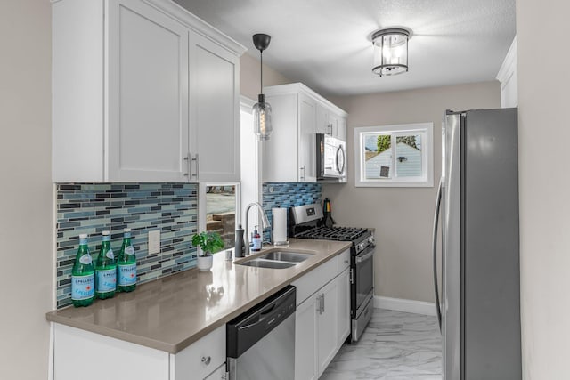 1332 Jersey Ave S, Saint Louis Park, MN 55426 - kitchen featuring white cabinets, marble finish floor, backsplash, a sink, and appliances with stainless steel finishes