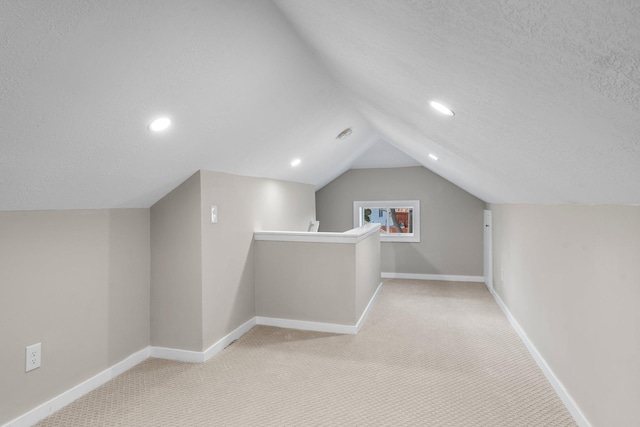 1332 Jersey Ave S, Saint Louis Park, MN 55426 - additional living space with carpet floors, lofted ceiling, a textured ceiling, and baseboards