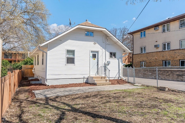 1332 Jersey Ave S, Saint Louis Park, MN 55426 - rear view of property with a fenced backyard and entry steps