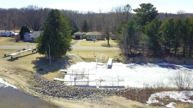 drone / aerial view featuring a wooded view
