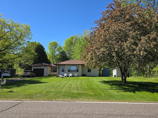 16099 Twilight Rd, Kathio Twp, MN 56359 - view of front of home featuring an attached garage, driveway, and a front yard