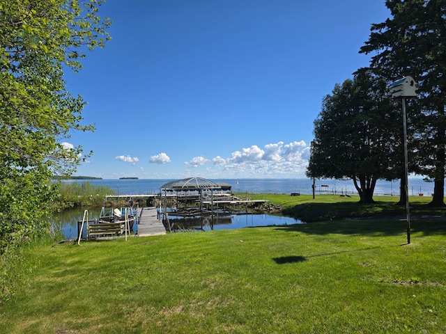16099 Twilight Rd, Kathio Twp, MN 56359 - dock area with boat lift, a water view, and a yard
