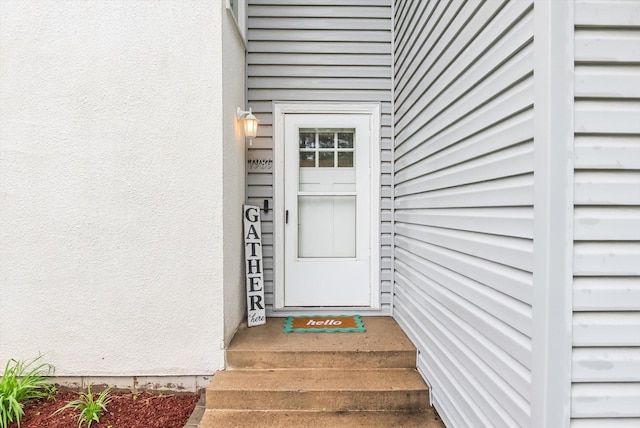 7986 Lad Pkwy, Brooklyn Park, MN 55443 - doorway to property with stucco siding
