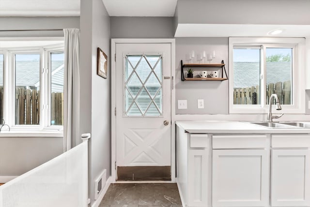 7986 Lad Pkwy, Brooklyn Park, MN 55443 - doorway featuring a sink and baseboards
