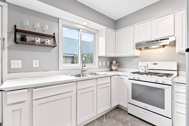 7986 Lad Pkwy, Brooklyn Park, MN 55443 - kitchen featuring white gas range oven, under cabinet range hood, a sink, white cabinetry, and light countertops