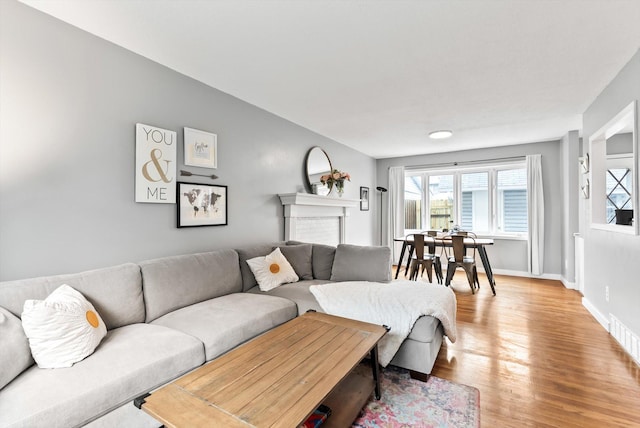 7986 Lad Pkwy, Brooklyn Park, MN 55443 - living room with healthy amount of natural light, light wood-type flooring, and baseboards