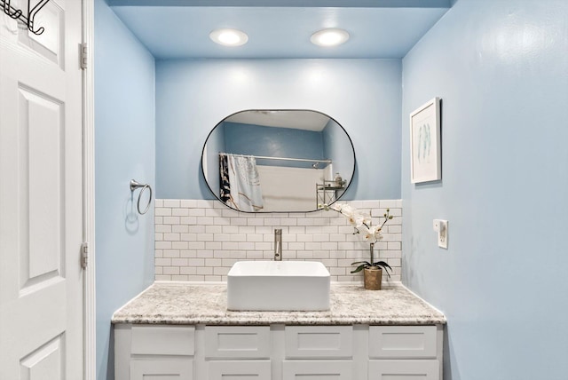 7986 Lad Pkwy, Brooklyn Park, MN 55443 - bathroom featuring tasteful backsplash and vanity