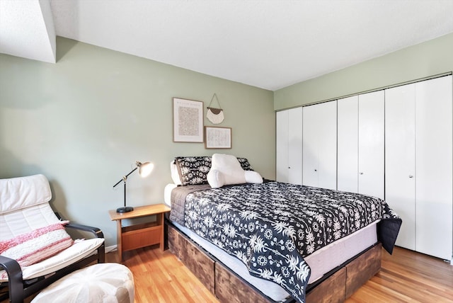 7986 Lad Pkwy, Brooklyn Park, MN 55443 - bedroom featuring light wood-type flooring, a closet, and baseboards