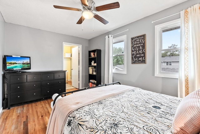 7986 Lad Pkwy, Brooklyn Park, MN 55443 - bedroom with light wood-style floors and ceiling fan