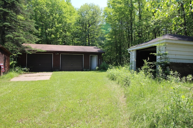 42491 432nd Ln, Aitkin, MN 56431 - view of yard with driveway, an outbuilding, and a garage